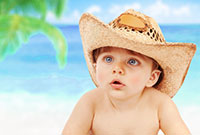 Baby Wyatt on beach in cowboy hat